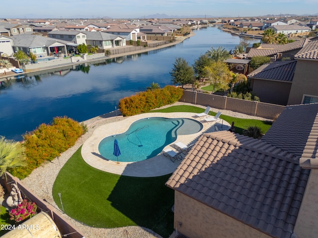 view of pool featuring a water view and a patio area