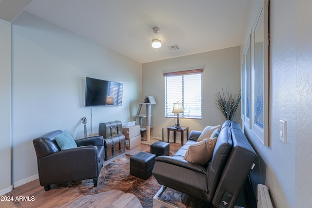 living room featuring hardwood / wood-style floors and ceiling fan