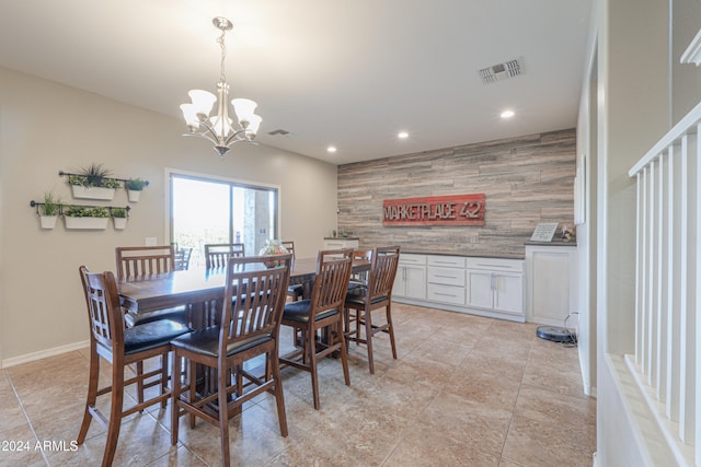 tiled dining space featuring an inviting chandelier