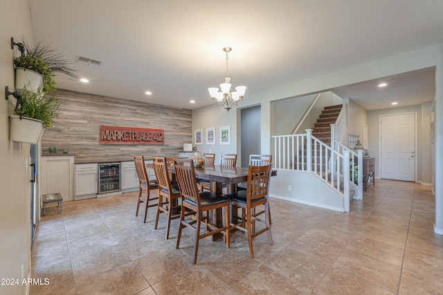 dining area featuring an inviting chandelier and beverage cooler