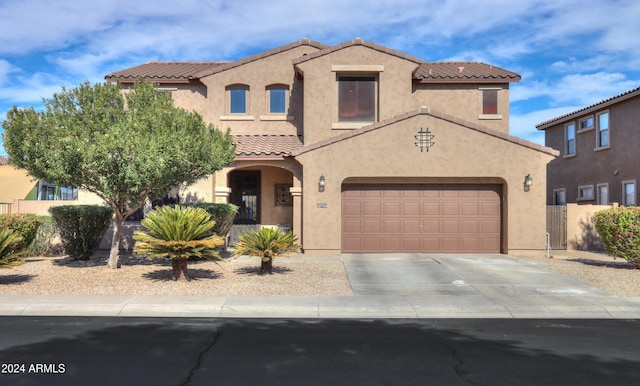 mediterranean / spanish home featuring a garage