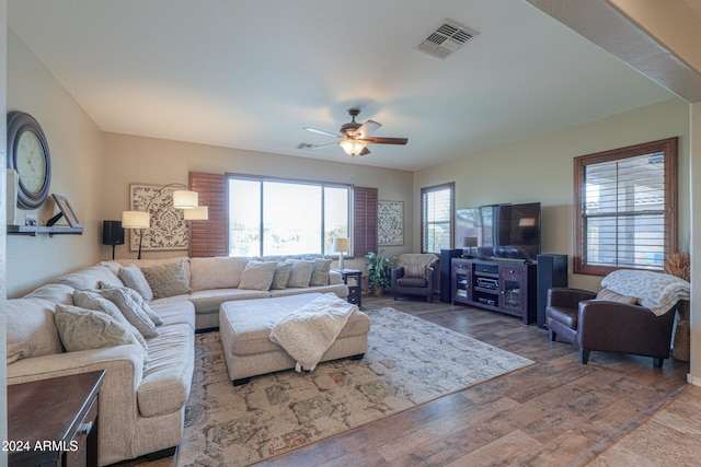 living room featuring ceiling fan and wood-type flooring