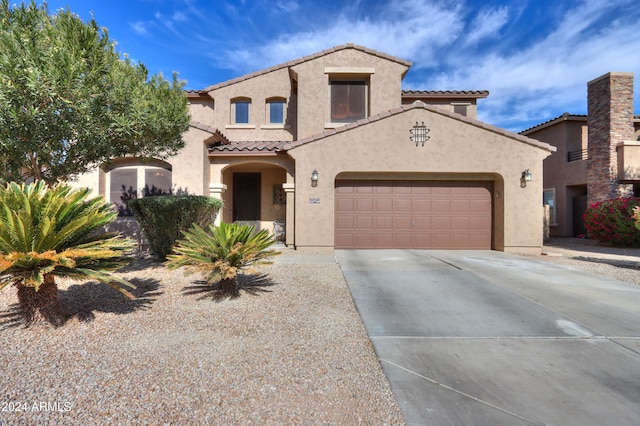 mediterranean / spanish-style house with a garage