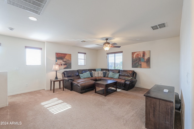 carpeted living room with ceiling fan