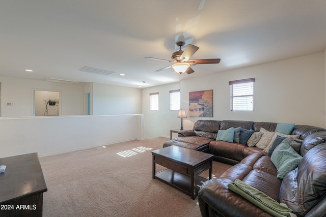 carpeted living room featuring ceiling fan