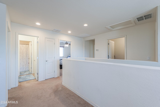 hallway with light colored carpet