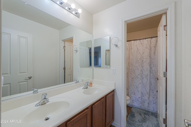 bathroom with a shower with shower curtain, vanity, and toilet