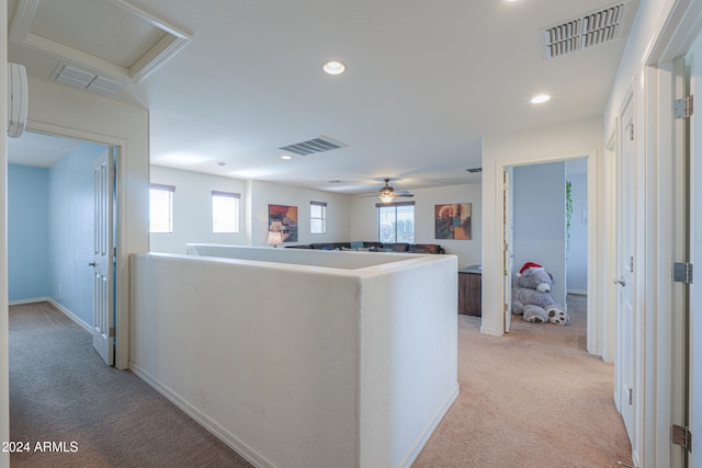 hallway with light colored carpet