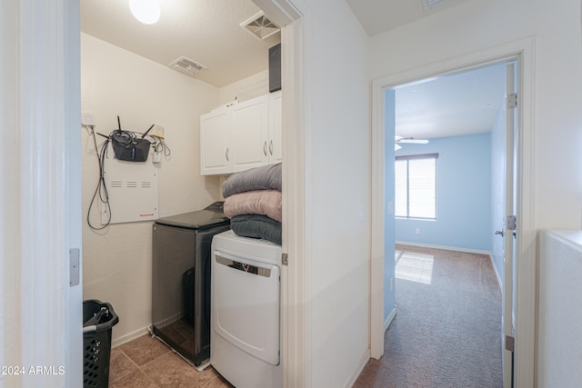 washroom with cabinets, light colored carpet, and washing machine and clothes dryer