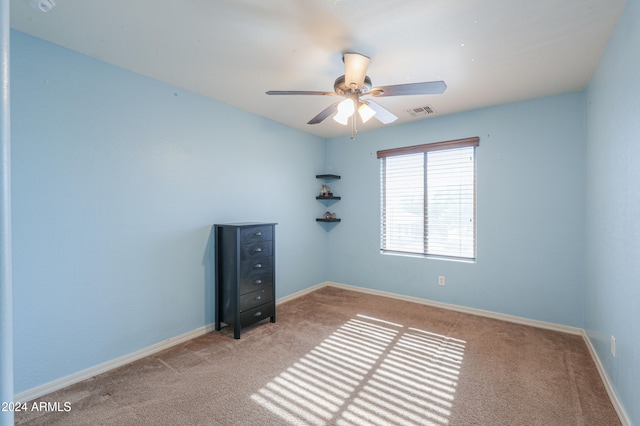 spare room featuring ceiling fan and light colored carpet