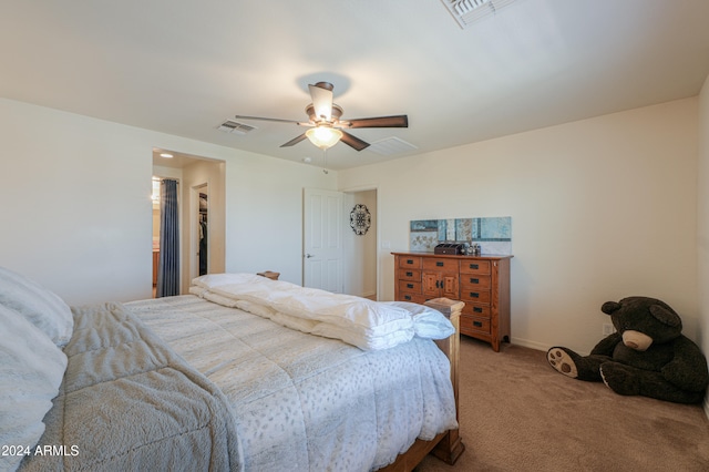 carpeted bedroom featuring a spacious closet, a closet, and ceiling fan