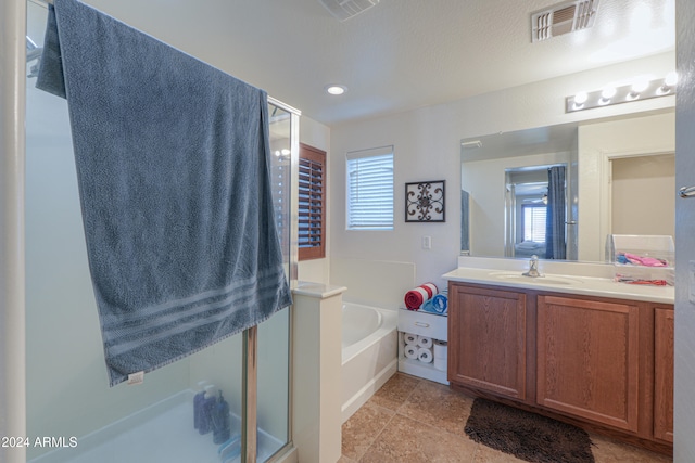 bathroom with plus walk in shower and vanity