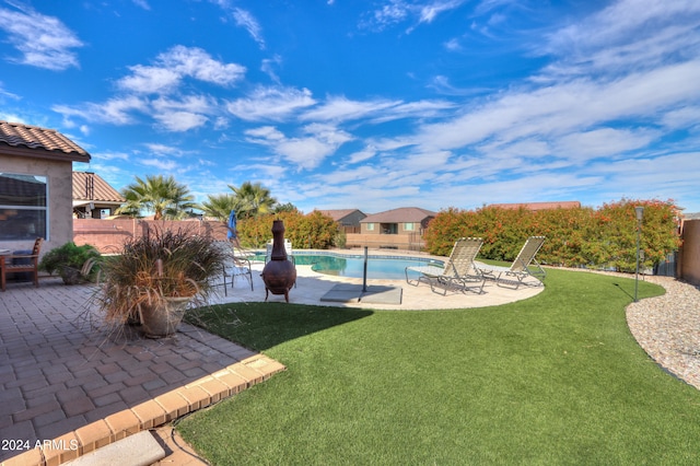 view of yard with a patio and a fenced in pool