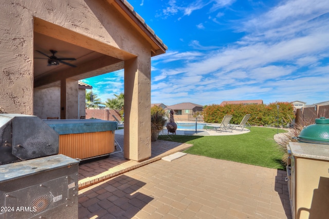 view of patio / terrace with a swimming pool with hot tub