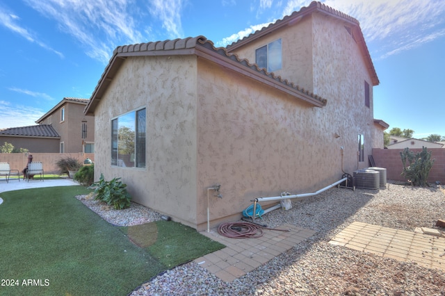 view of home's exterior featuring a yard and cooling unit