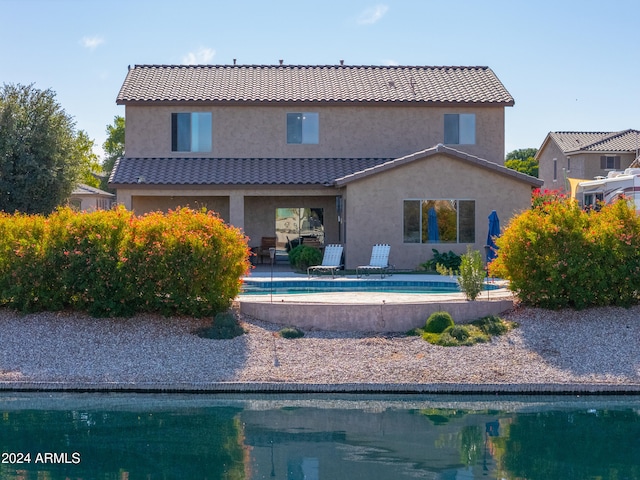 back of property with a patio