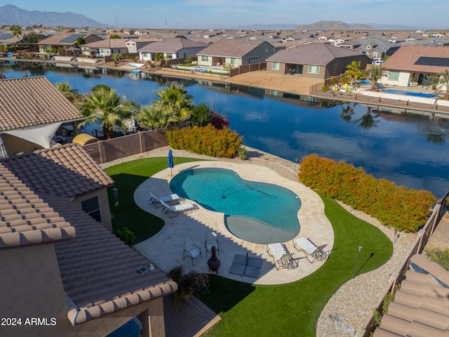 view of pool with a patio and a water and mountain view