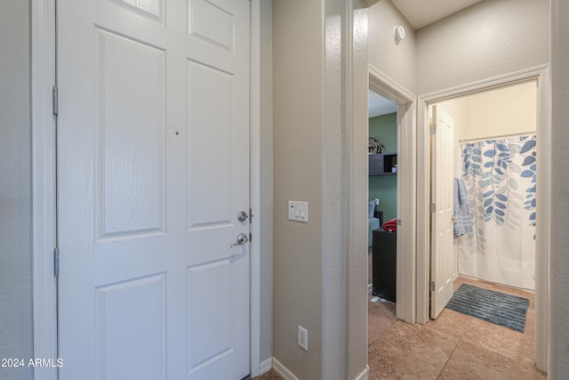 hallway featuring light tile patterned floors