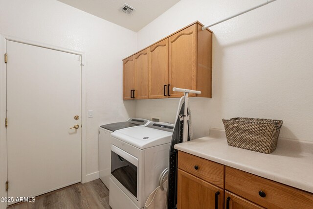 1635 E Harrison St, Chandler, AZ 85225 - washroom featuring cabinet space, washing machine and dryer, and light wood-type flooring