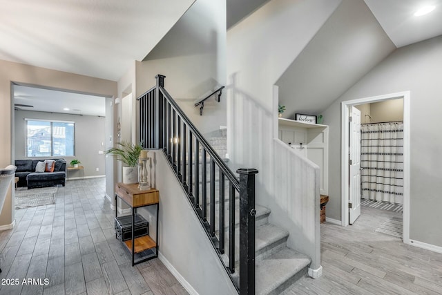 stairway with lofted ceiling