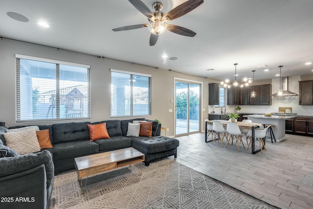 living room with ceiling fan and sink