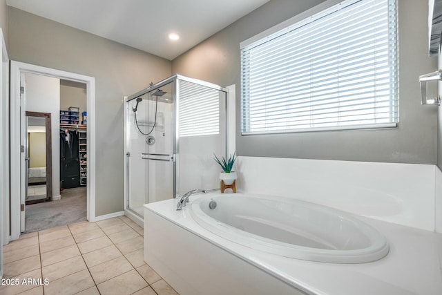 bathroom with tile patterned flooring and separate shower and tub