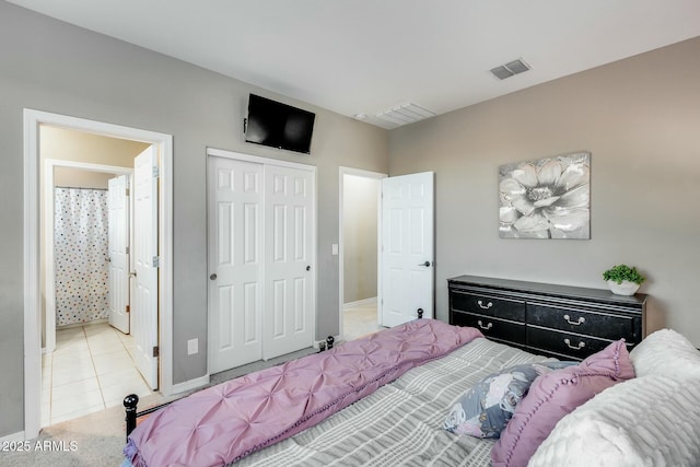 tiled bedroom featuring a closet