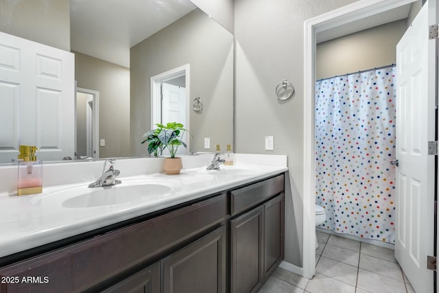 bathroom with tile patterned floors, vanity, toilet, and curtained shower