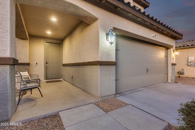 exterior entry at dusk with a garage