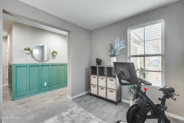 workout room with light wood-type flooring and plenty of natural light