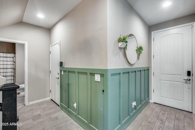 entryway featuring vaulted ceiling and light wood-type flooring