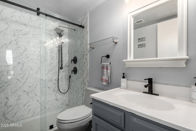 bathroom featuring a shower with door, visible vents, toilet, and vanity