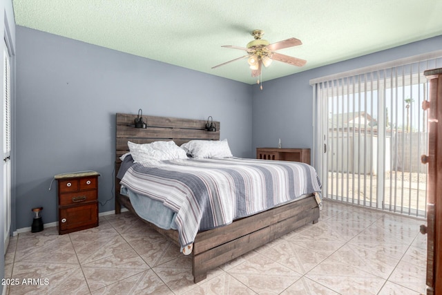 bedroom with access to outside, a ceiling fan, baseboards, and a textured ceiling