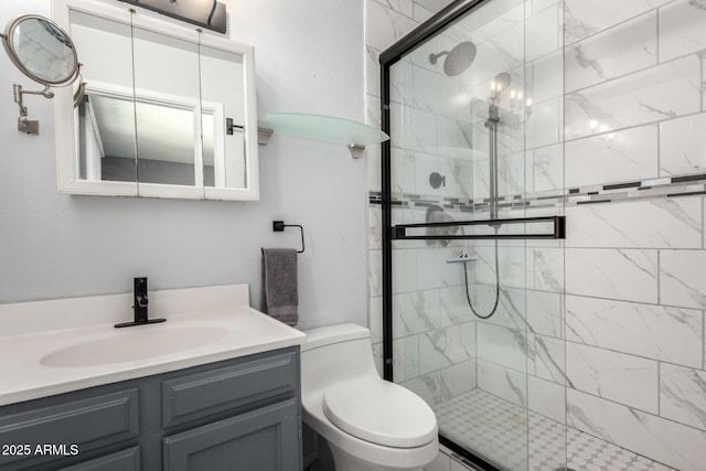 bathroom featuring toilet, a stall shower, and vanity