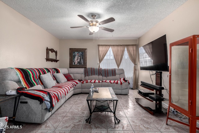 living room with tile patterned floors, a textured ceiling, and a ceiling fan