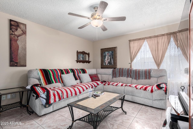 living room with light tile patterned floors, a textured ceiling, and ceiling fan