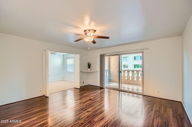 spare room featuring dark wood-type flooring and ceiling fan