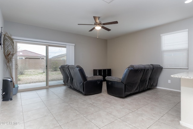 living room with ceiling fan and light tile patterned floors