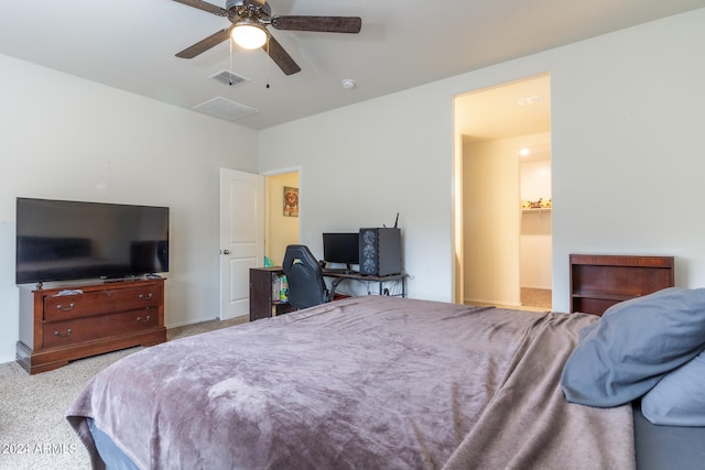 carpeted bedroom featuring connected bathroom and ceiling fan