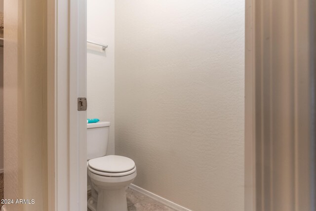 bathroom with tile patterned floors and toilet