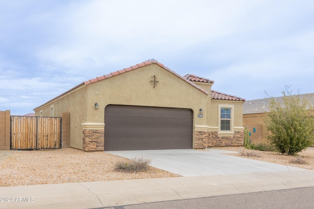 mediterranean / spanish-style home with a garage