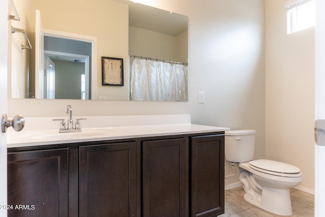 bathroom featuring toilet, vanity, and tile patterned flooring