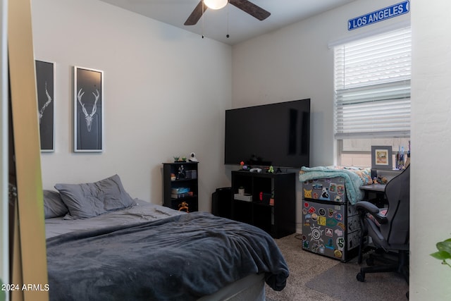 bedroom with ceiling fan, multiple windows, and carpet