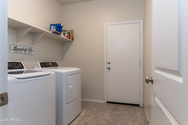 laundry area featuring light tile patterned flooring and independent washer and dryer