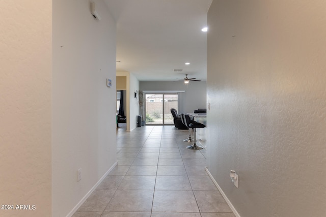 hall featuring light tile patterned flooring