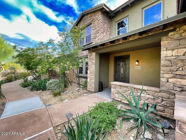 18507 N 94th St, Scottsdale, AZ 85255 - doorway to property with stone siding and stucco siding
