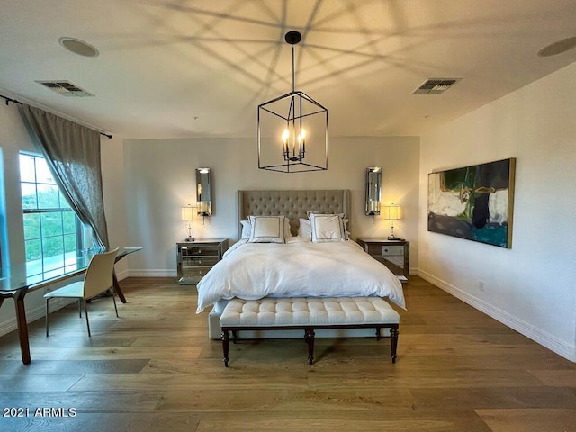 18507 N 94th St, Scottsdale, AZ 85255 - bedroom with wood finished floors, visible vents, and baseboards