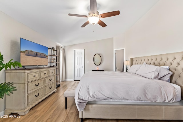 bedroom featuring lofted ceiling, light wood finished floors, a ceiling fan, and baseboards