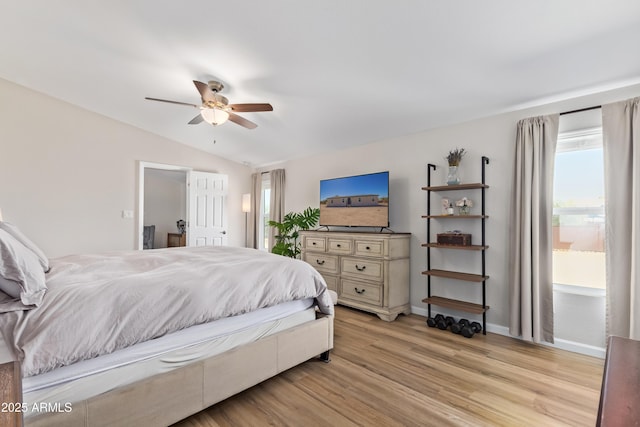 bedroom featuring a ceiling fan, baseboards, vaulted ceiling, and light wood finished floors