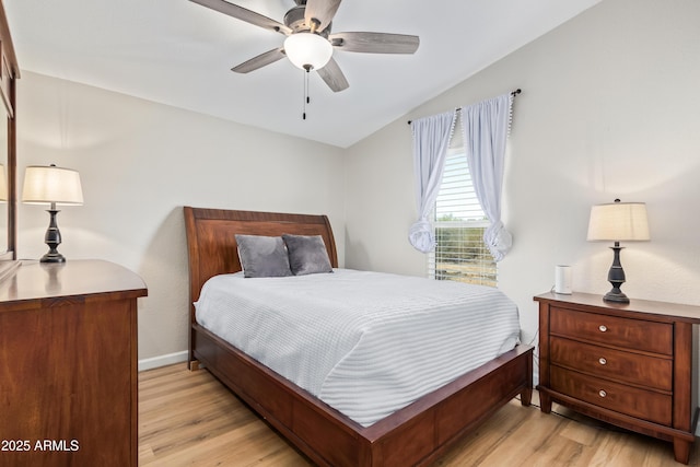 bedroom featuring light wood-type flooring, a ceiling fan, and baseboards